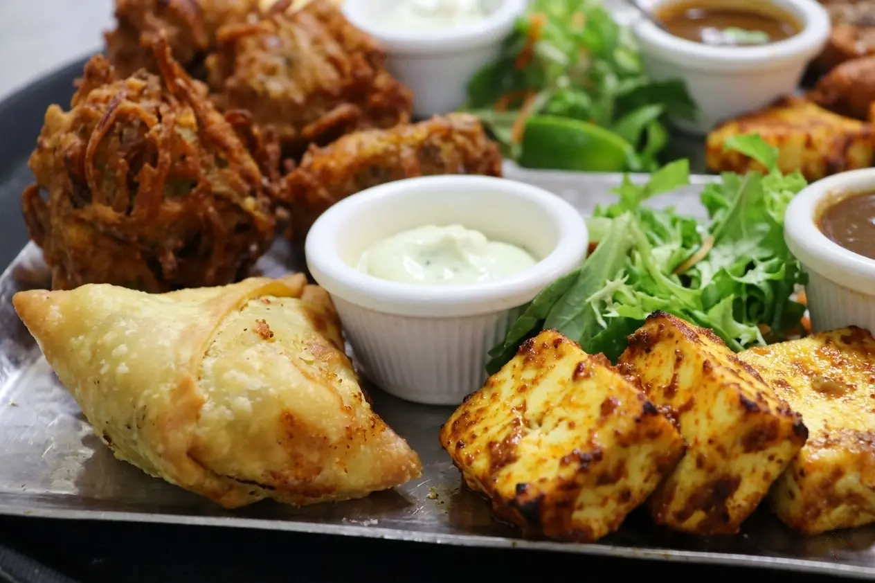 Authentic Indian dishes including samosa and chicken tikka served at The India Restaurant Cannon Street London